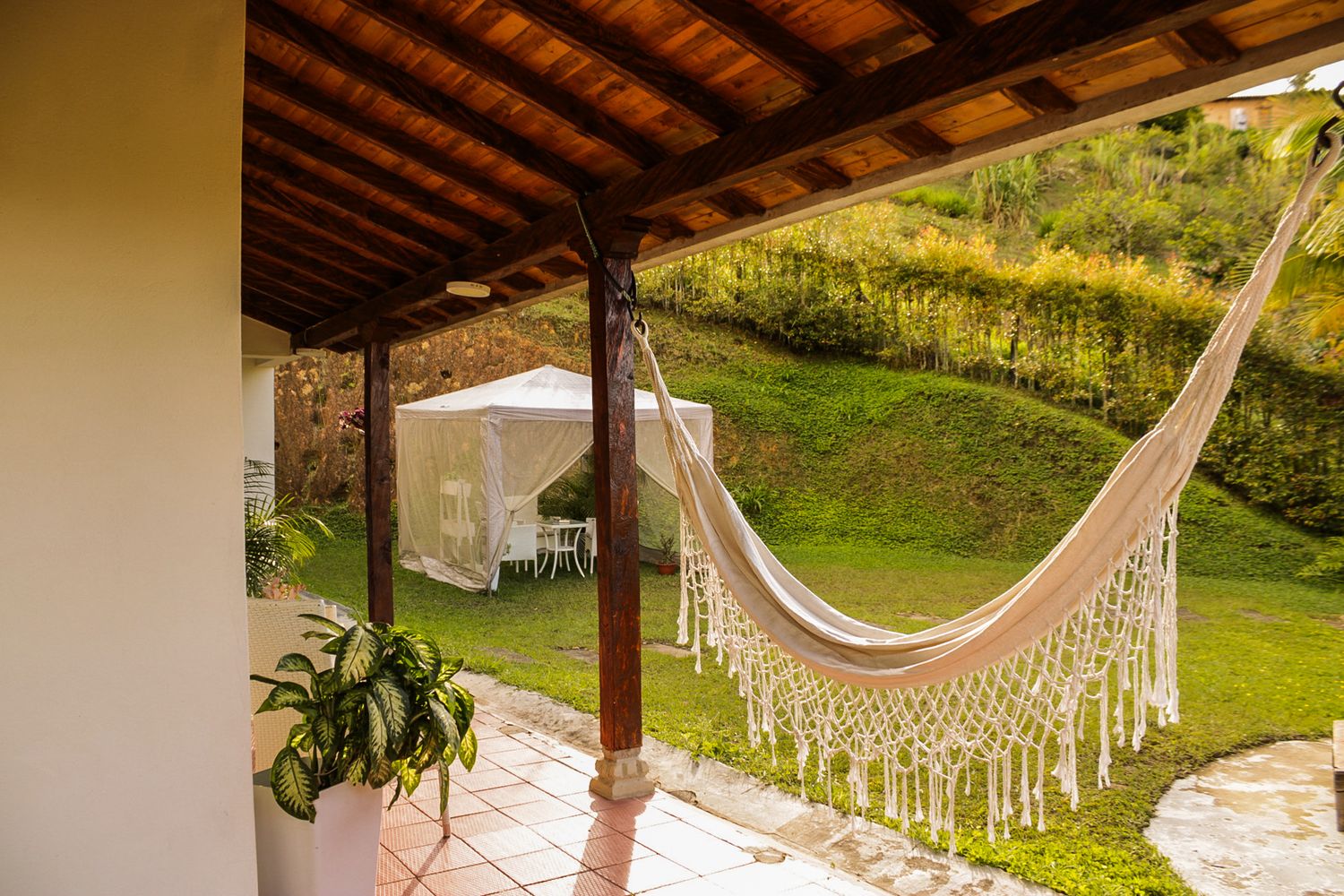 Terraza de Casa Taná con hamaca y vista a la montaña, Antioquia, Colombia